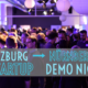 menschen in lila licht getaucht bei der startup demo night in nürnberg